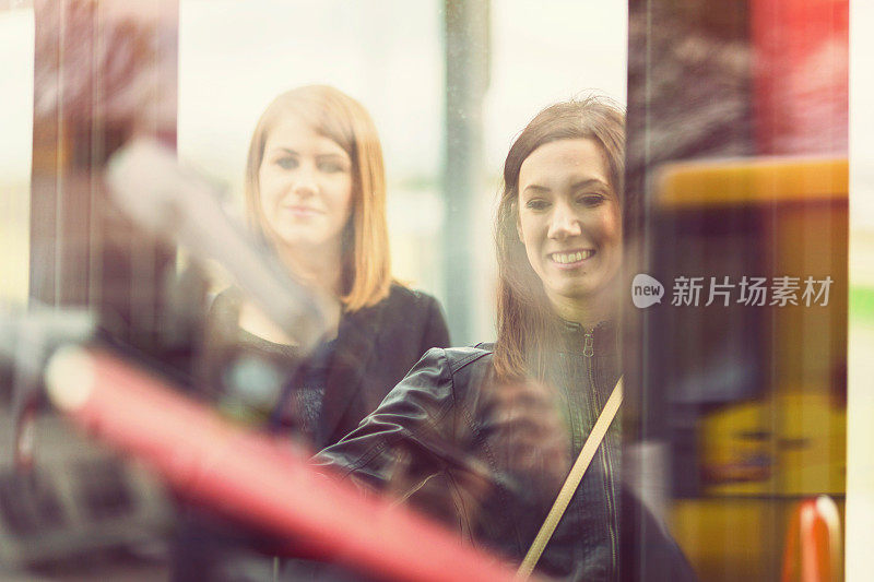 Young women waiting on the bus station